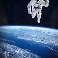 An astronaut floating inside a spacecraft in microgravity.