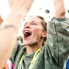 An enthusiastic person gives a thumbs-up at an action-sports event.