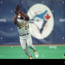 Rickey Henderson in a baseball outfield uniform.