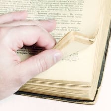 Person turning through the pages of a book