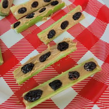 Celery filled with peanut butter and topped with raisins to resemble ants on a log.