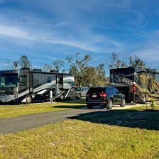 Several recreational vehicles parked at a campground.