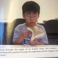 A person rapidly reading a book and turning its pages