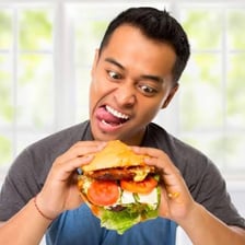 A person swallowing a large mouthful of food