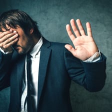 A person making a sympathetic expression while reacting to disappointing news.