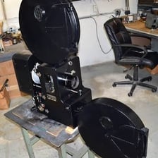 A reel of motion-picture film mounted on a projector