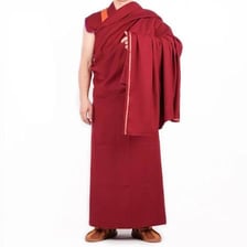 A Tibetan Buddhist lama wearing traditional monastic robes.