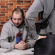 A suspect speaking during a police interrogation.