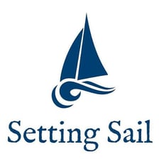 A sailboat leaving a harbor under sail