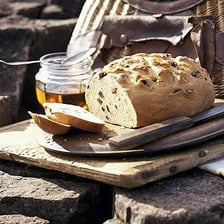 Slices of rye bread arranged beside a loaf.