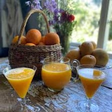 Several glasses of orange juice served at breakfast.