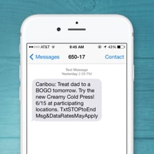 A smartphone displaying a text message with the abbreviation IMO