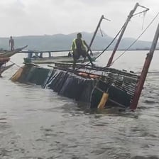 A small boat overturned in the water.