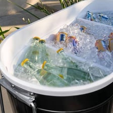 Ice surrounding beverage cans inside a cooler