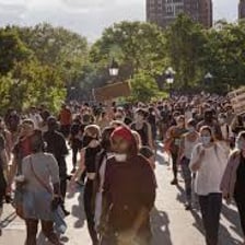A disorderly crowd in a city street during a riot