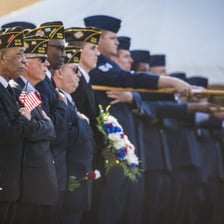 Uniformed military personnel giving a salute