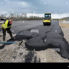 Fresh black tar spread across a roadway.