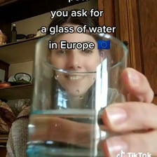 A person reaching for or asking for a drink.