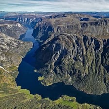 A narrow sea inlet bordered by steep mountain cliffs.