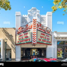 The exterior of a cinema with a movie marquee.