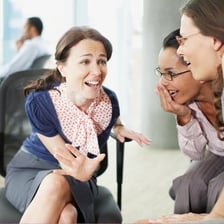 A group of people speaking privately together.