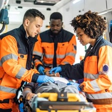 Emergency medical technicians beside an ambulance.