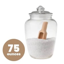 A container of Epsom salts beside a bathtub.