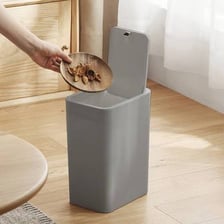 A trash can fitted with a closed lid