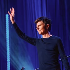 Comedian Tig Notaro performing on a stand-up stage