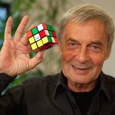Ernő Rubik holding a Rubik’s Cube