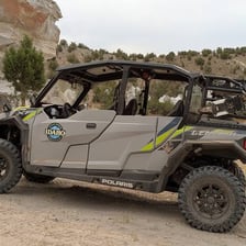 An all-terrain vehicle driving on an off-road trail