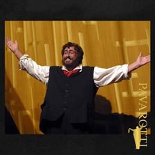 Luciano Pavarotti singing in an opera performance