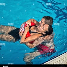 A lifeguard helping a swimmer in distress
