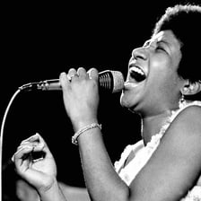 Aretha Franklin performing with a microphone
