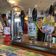 A pint of ale on a pub counter