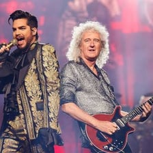 Singer Adam Lambert performing onstage.