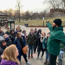 A guide leading a group of people.