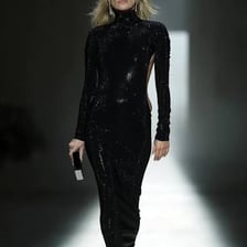 Kate Moss walking in a fashion show.