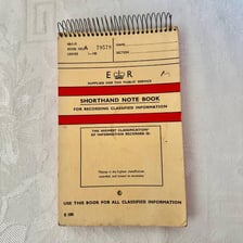 A vintage office stenographer taking shorthand notes