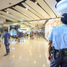 A uniformed security guard patrolling a shopping center
