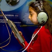A radio operator communicating through a microphone