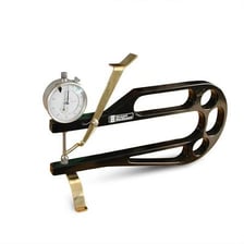 A caliper measuring the thickness of a small object.