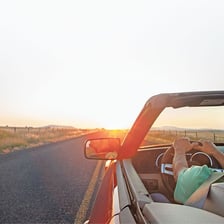 A driver steering a car along a road toward a chosen direction