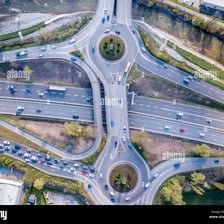 An aerial view of highways joining at an intersection.