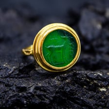 A gemstone showing an engraved intaglio design.