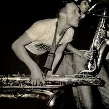 Musicians performing ska with brass instruments.