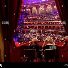 A private box overlooking the seats in an ornate theater.