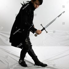 A person holding and using a sword