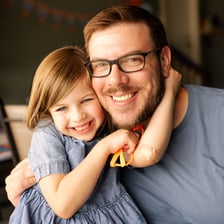 A father pictured with a child.