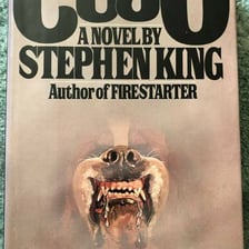 A book cover for Stephen King’s horror novel Cujo.